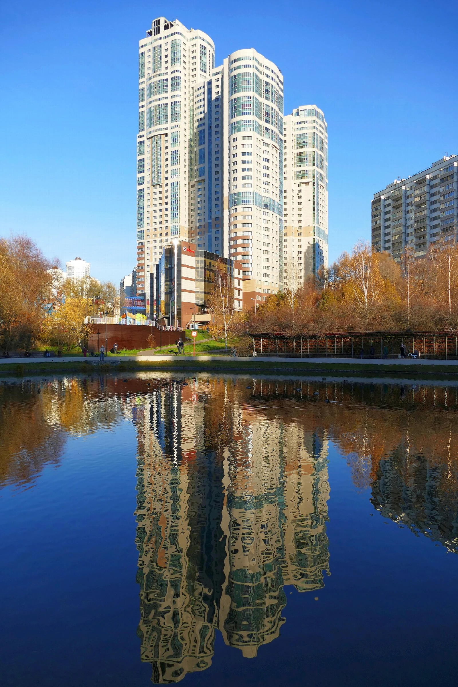 View of Zapyataya Pond and WellHouse residential complex on Leninsky Prospekt (house 111, building 1) from Yugo-Zapadniy forrest park. Moscow, Russia.